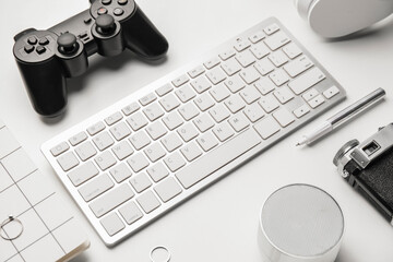Computer keyboard and different modern devices on white background - obrazy, fototapety, plakaty