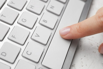 Female hand with computer keyboard, closeup