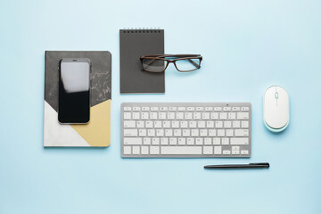 Composition with computer keyboard, mouse and mobile phone on color background
