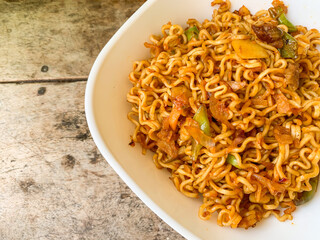 indonesian instant noodle served in white bowl.