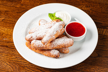 deep fried donuts with berry sauce