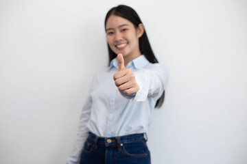 Young Asian woman showing thumb isolated on white background.