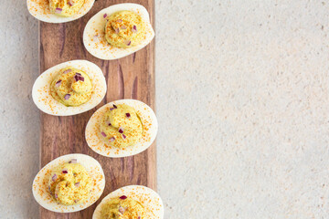 Deviled eggs with  maionese, mustard, chopped red onion and paprika. Appetizer. Top view. Copy space.