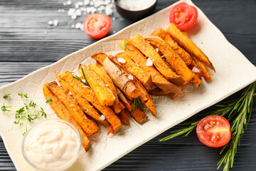 Plate with tasty cooked sweet potato on wooden background
