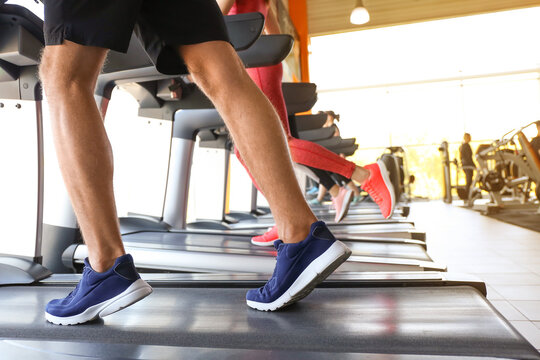 People training on treadmills in gym