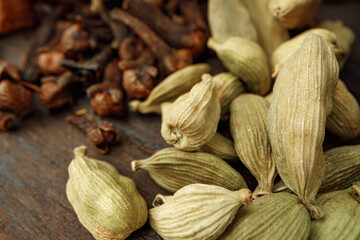Сardamom spice bunch on wooden table macro