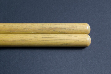 wooden drum sticks on black background