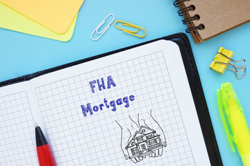 Business concept about FHA Mortgage with inscription on the sheet.