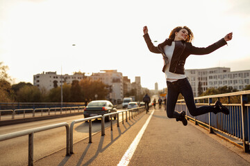 Fototapeta na wymiar Happiness and energetic fresh portrait of young woman excited jumping up