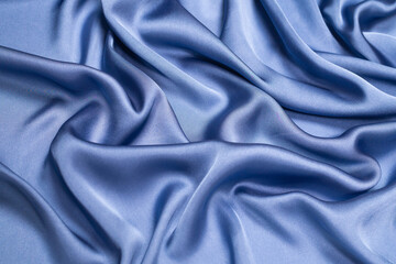 Blue silk or satin luxury fabric texture. Top view.