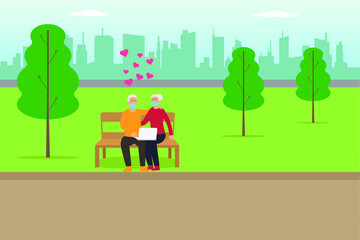 Happy gray hair senior couple wearing face mask and sitting on the bench at the park while using laptop computer with heart symbol