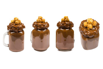 Chocolate milkshake with whipped cream, cookies, waffles, served in glass mason jar. 