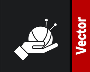 White Yarn ball with knitting needles icon isolated on black background. Label for hand made, knitting or tailor shop. Vector.