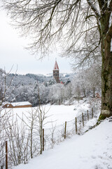 tower of saint-maurice abbey in luxembourg in winter landscape