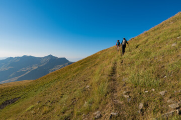 Fototapeta na wymiar Two young women hiking on Grammos mountain