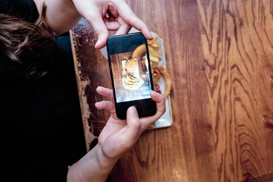 Hands taking a photo of lunch to share on social media. Food photography. Copy space.