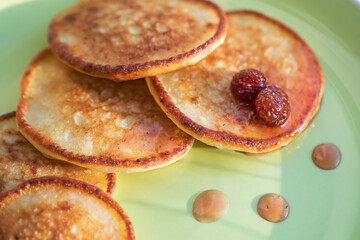 Homemade cottage cheese pancakes with strawberry jam. Traditional Russian cuisine.
