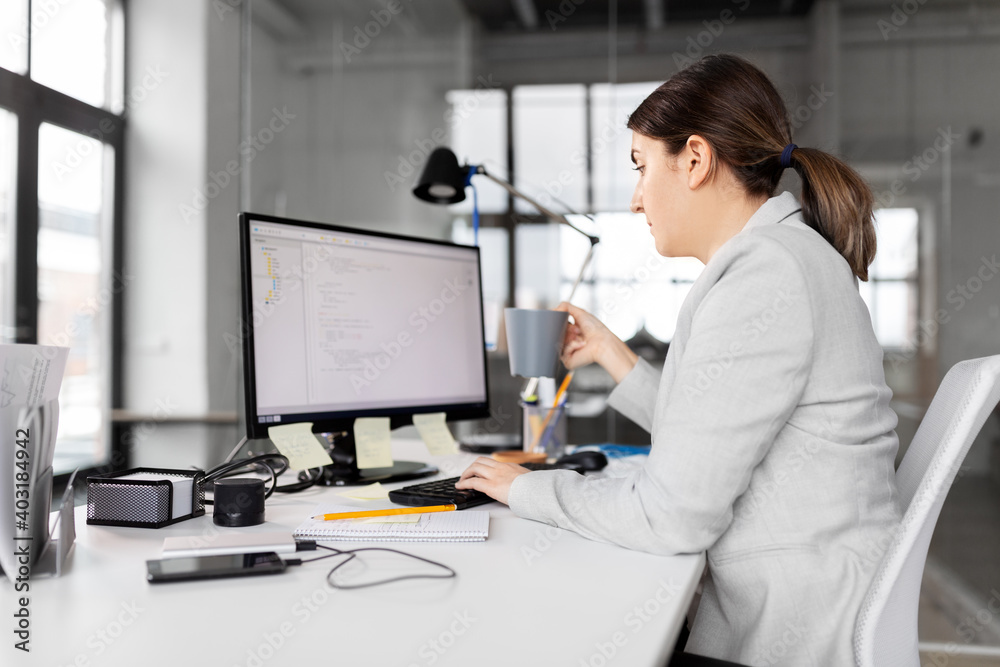 Wall mural business, startup and people concept - businesswoman with computer and coffee working at office