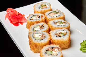 Set of sushi rolls on a white plate. Close-up, selective focus
