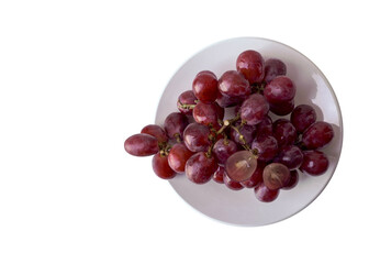 top view a bunch of purple grapes placed on a white dish on white background, fruit, copy space