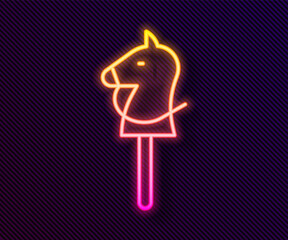 Glowing neon line Toy horse icon isolated on black background. Vector.