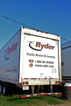 Ryder Truck parked on green grass with blue sky and a power line in the day time in Hutchinson  Kansas USA.