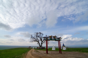 Fototapeta na wymiar Pagoda and ritual drum and stupa with Buddhist symbols. Location Republic of Kalmykia