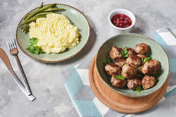 Swedish meatballs with mashed potatoes and green beans.