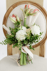 Delicate bouquet of white peonies and hippeastrum. Wedding accessories
