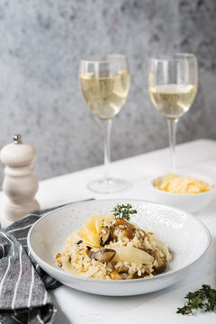 Risotto with porcini mushrooms and parmesan on a light background