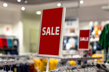 Retail Image Of A Sale Signs In A Clothing Store. Front view from the side. Holiday big discounts.