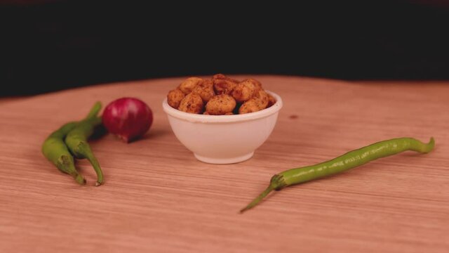 indian food shing bhujia on wooden table,masala coated peanuts indian snack,chivda indian snacks group of Indian Traditional Spicy And Sweet Namkeen Food,Namkeen, Farsan,
