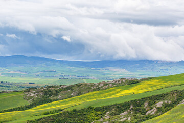 Valley with fields and dark clouds in the sky