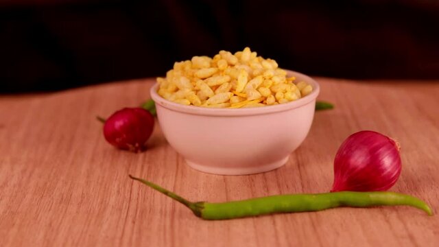 Sev Mamra is an Indian snack. garlic & spices sev mamra,sav murmara,Namkeen, Farsan,Indian spicy snack Namkeen mixture with fried cashew nuts and almonds,savory, Namkeen in a bowl wooden background