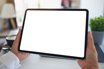 Mockup image of a woman holding digital tablet with blank white desktop screen