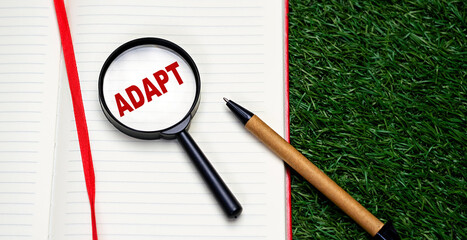 Word ADAPT written on notebook red letters