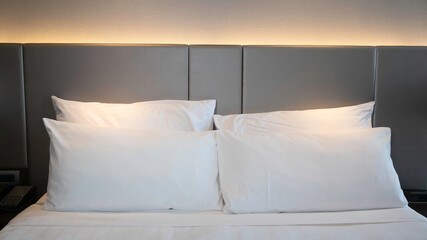 Selective focus of Bedroom with White pillows, duvet and duvet case in the night mood