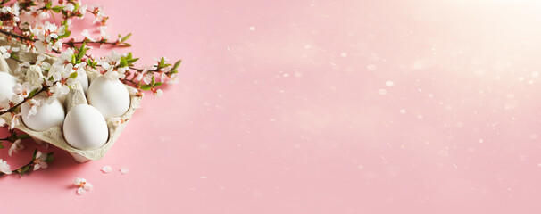 White eggs and twigs with flowers on pink background