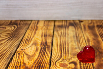 Big heart lying on a wooden background with place for text..