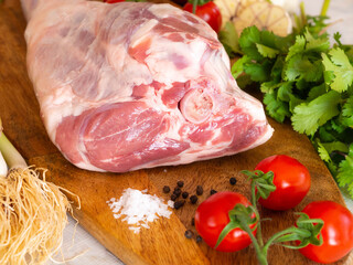 Fresh and raw meat. Leg of lamb on wood background