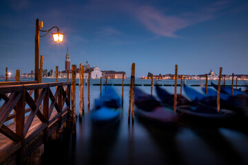 Gondola park at Pizza San Marco at dusk. looking over the grand canal towards san giorgio maggiore