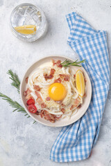 Classic carbonara pasta with fried bacon, parmesan cheese and egg yolk.
