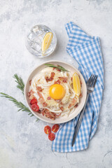Classic carbonara pasta with fried bacon, parmesan cheese and egg yolk.