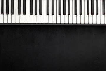 Desk of musician for songwriter work set with headphones and synthesizer