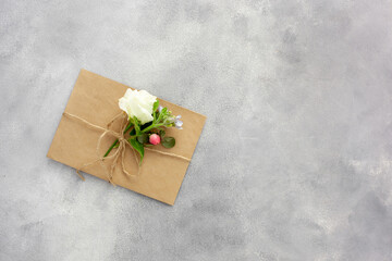 Postcard with open kraft paper envelope filled with spring flowers