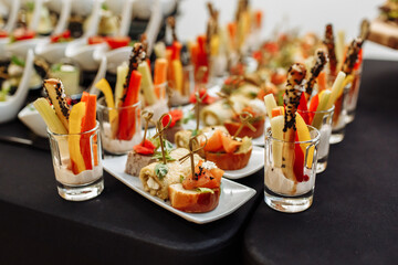 Festive Buffet. An assortment of cold cuts and canapes on wooden skewers. Cocktail reception at the...