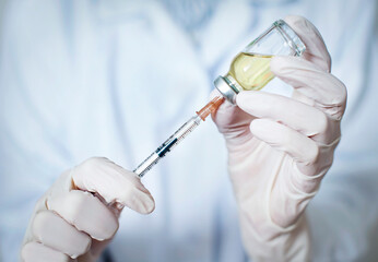 a nurse draws a vaccine into a syringe. close-up. vaccination concept covid-19
