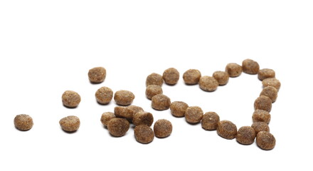 Dog food, dry round granules in heart shape isolated on white background