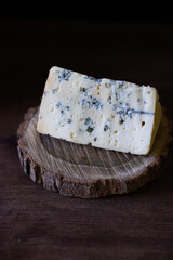 blue cheese on a wooden frame on a wooden background in rustic style