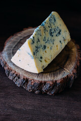 blue cheese on a wooden frame on a wooden background in rustic style